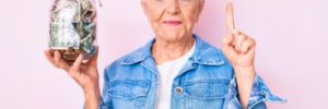 Grandma with jean jacket holding jar of money