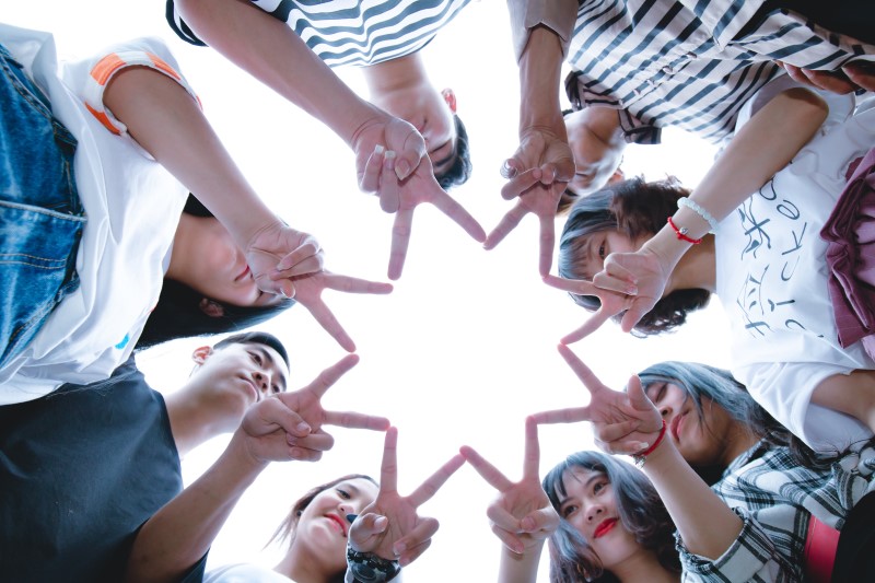 Youth gathering to form a star symbol