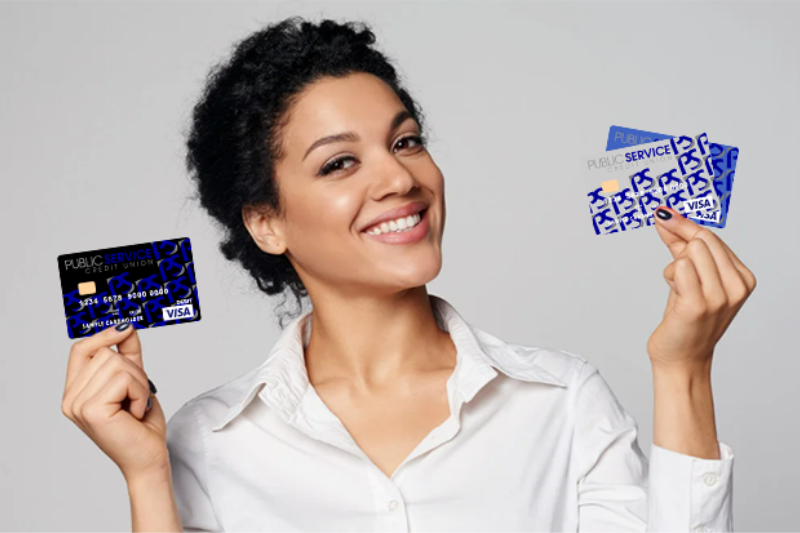 WOMAN HOLDING PSCU DEBIT AND CREDIT CARDS